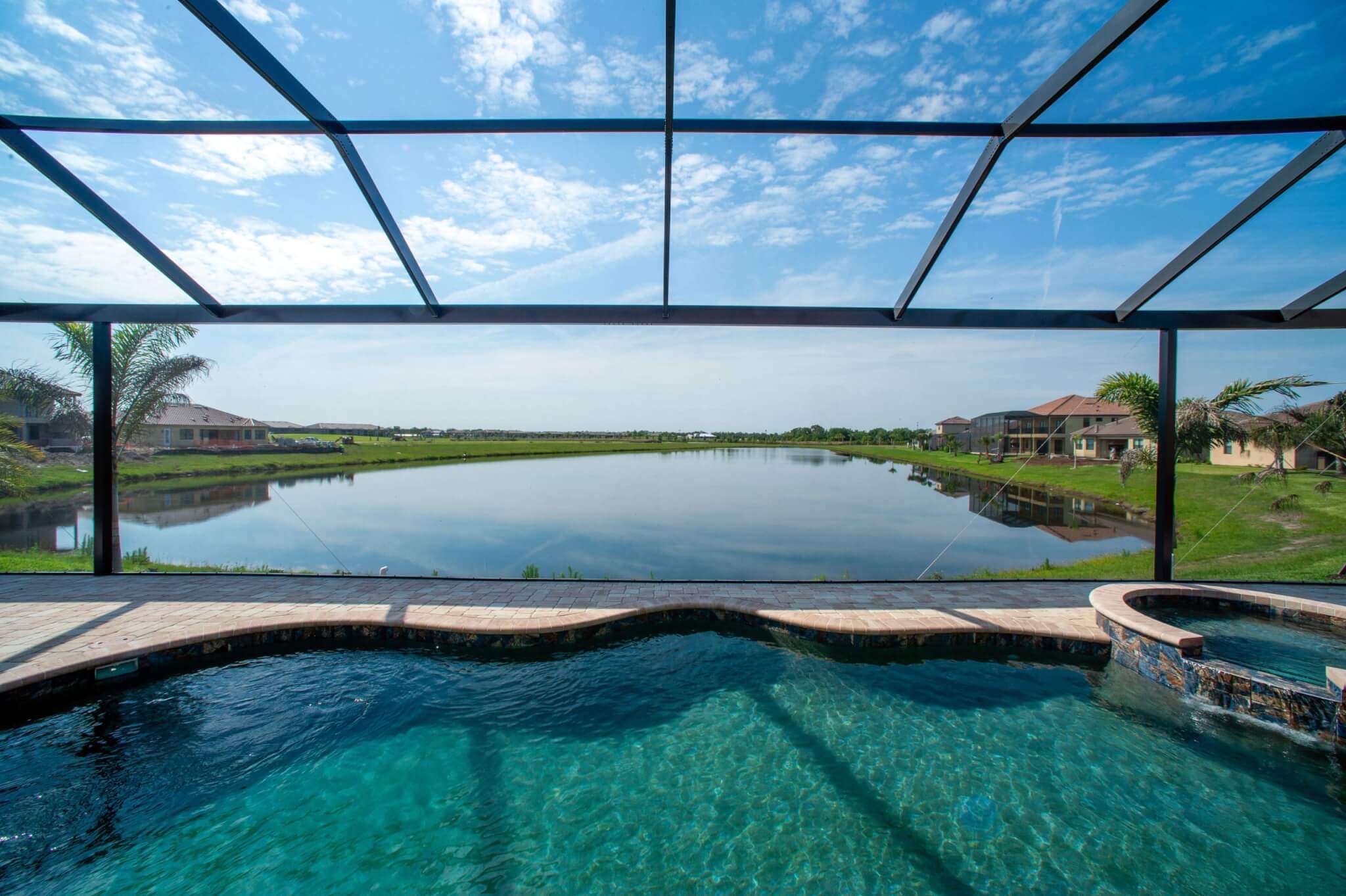 Screened pool and patio overlooking the water
