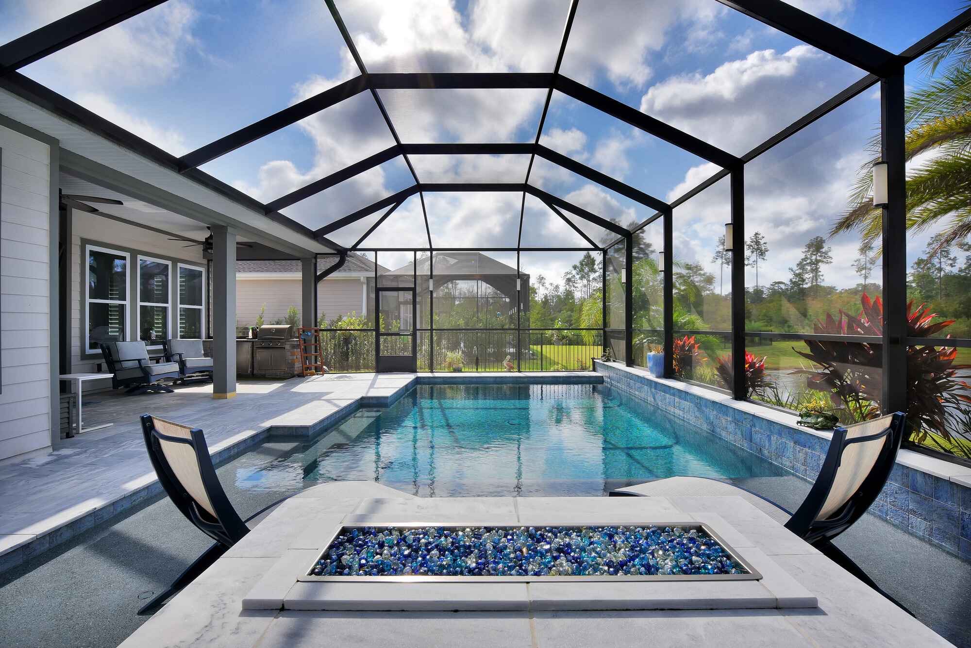 Aluminum pool cage and screen enclosure with beautiful pool area