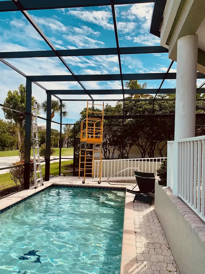 Existing pool cage extension—seamless aluminum addition over a screened pool