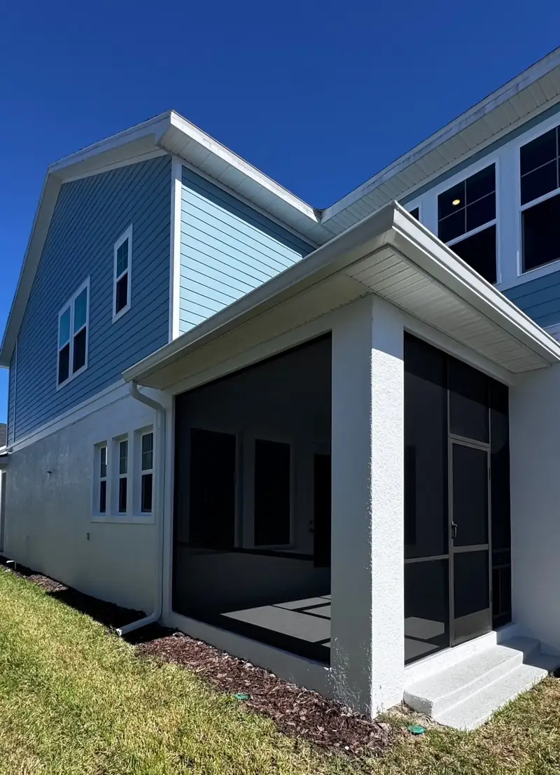 Aluminum screen enclosure attached to a home